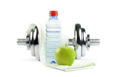 Metal dumbell with green apple, bottle of water and towel. Metal dumbell with green apple, bottle of water and towel. Isolated on white